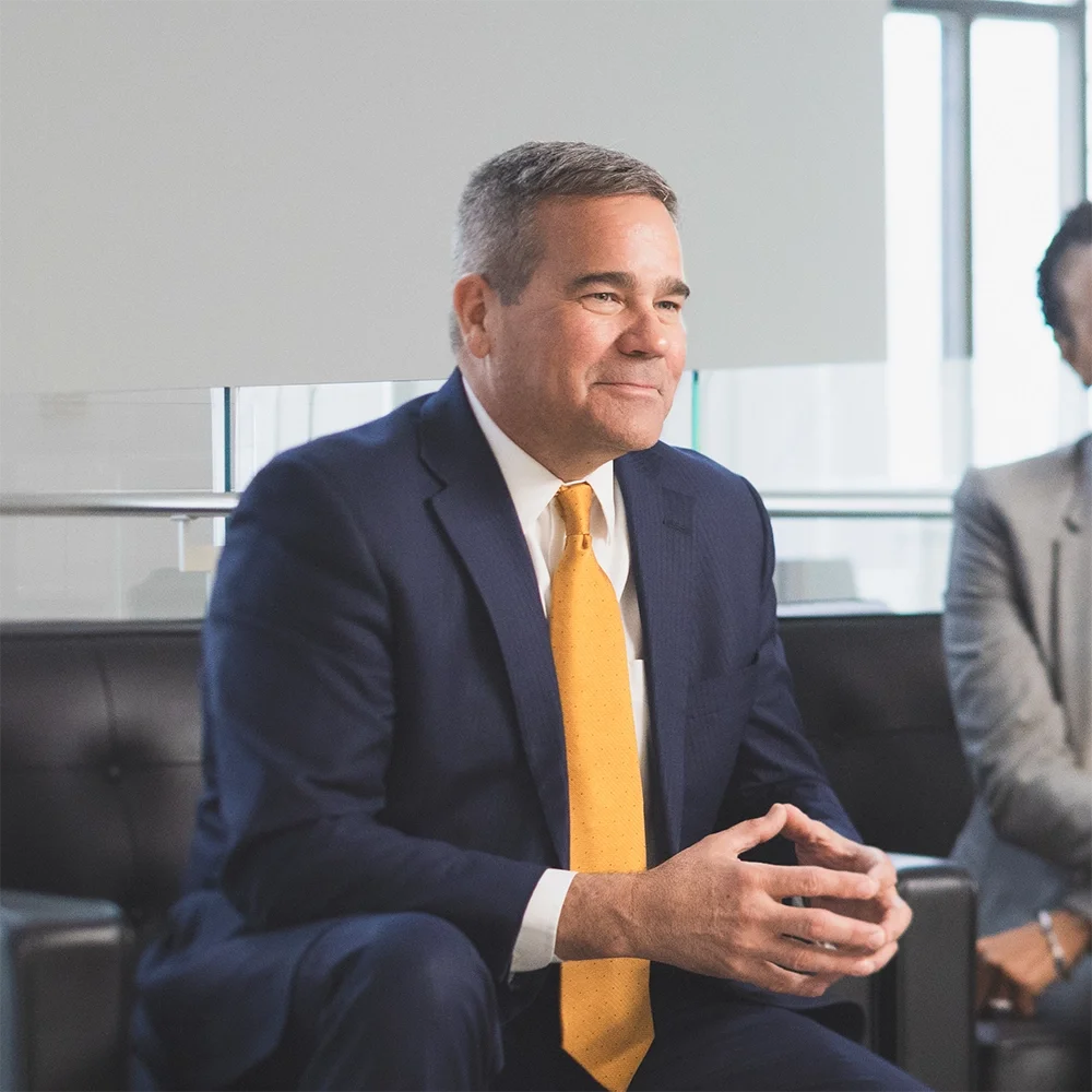 Principal CEO Dan Houston sits with a colleague during a meeting.