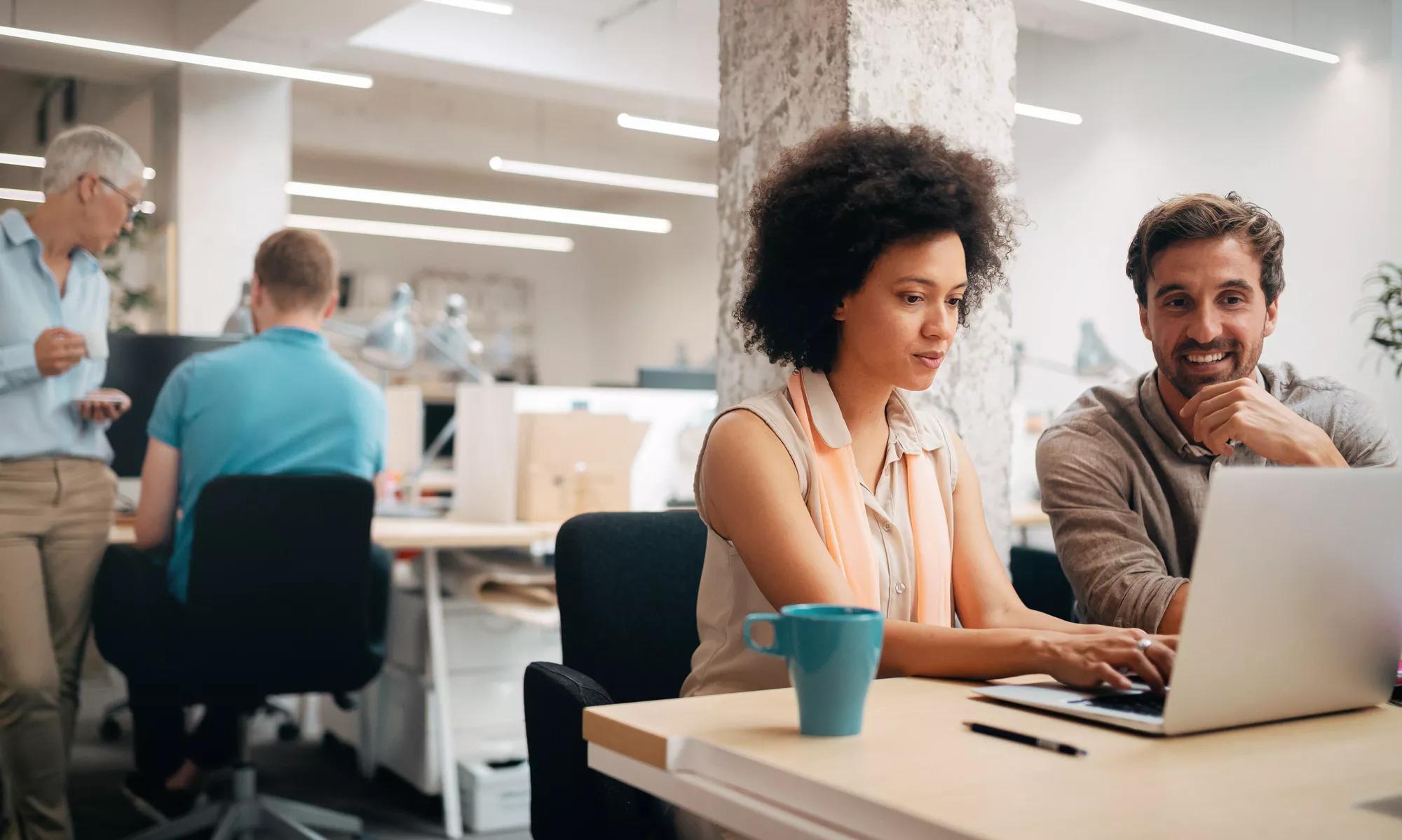 Team of colleagues brainstorming together while working in modern office. Team of colleagues brainstorming together while working in modern office.