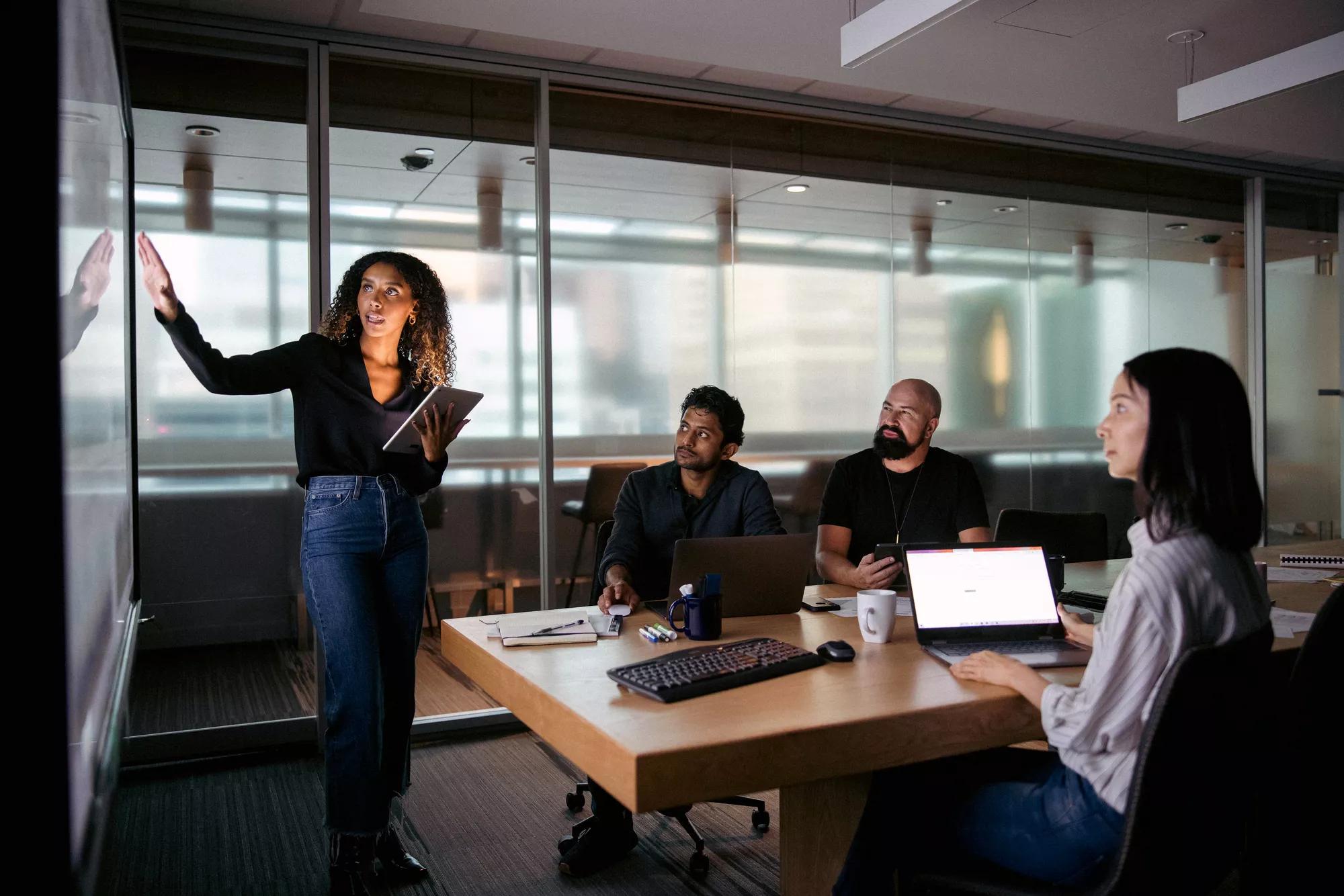 Employee giving a presentation in front of colleagues Employee giving a presentation in front of colleagues