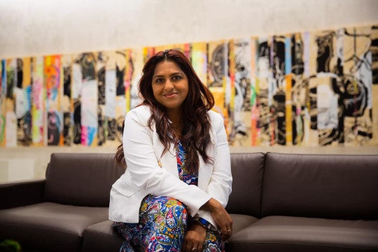 Erin Kakkanad sitting on a couch