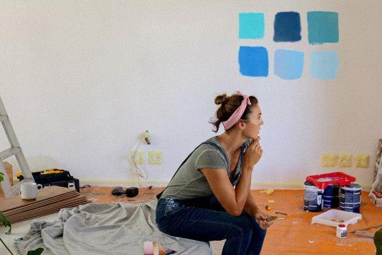 A woman considering paint colors in her home.