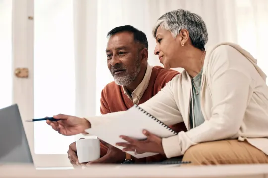 Mature man and woman going over their finances.