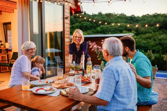 A family eating in their backyard.