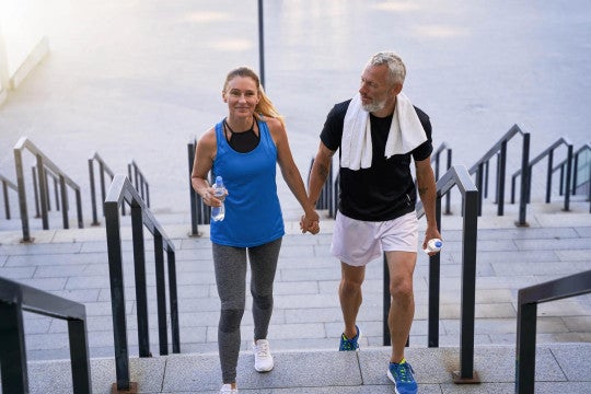 Man and woman in workout clothes on stairs