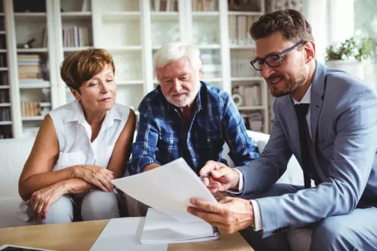 Couple nearing retirement discussing retirement income with financial professional
