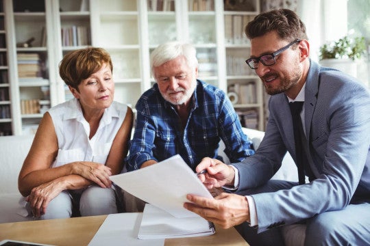 Couple nearing retirement discussing retirement income with financial professional