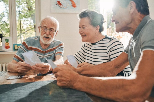 Older couple reviewing paperwork with family member.