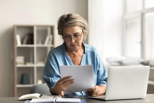 A woman reviewing her finances to consider debt consolidation