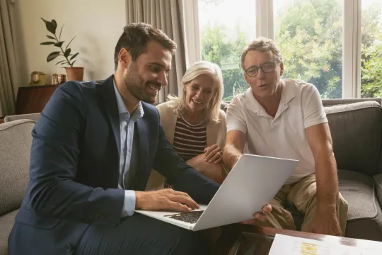 Couple meeting with financial professional to review savings.
