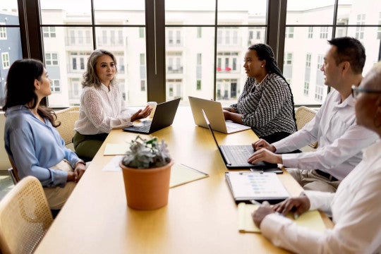 Small group of people meeting to discuss Secure 2.0 Act.