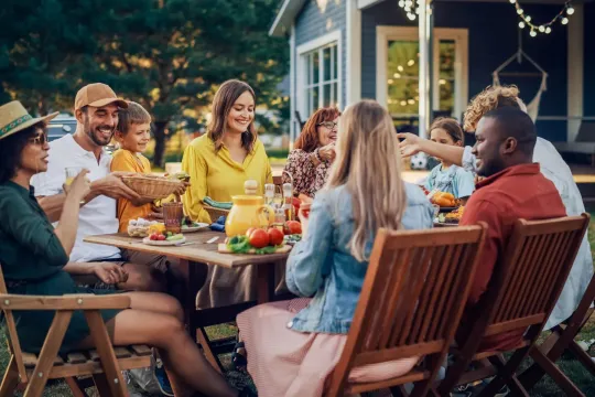 A family eating in their backyard.