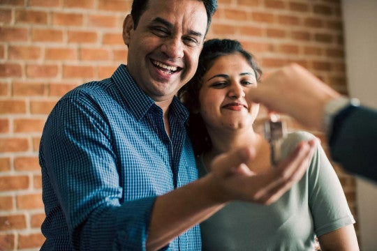 Couple receiving house keys.