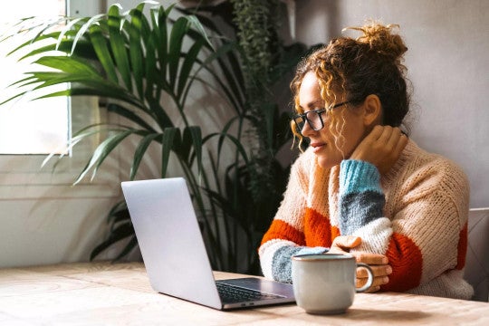 Woman reviewing her retirement savings accounts on a computer