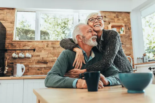 Smiling older man and woman in their home.