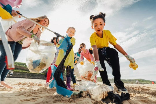 Adults and kids volunteering outside
