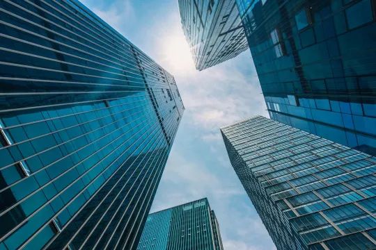 Looking up towards the top of several skyscrapers.