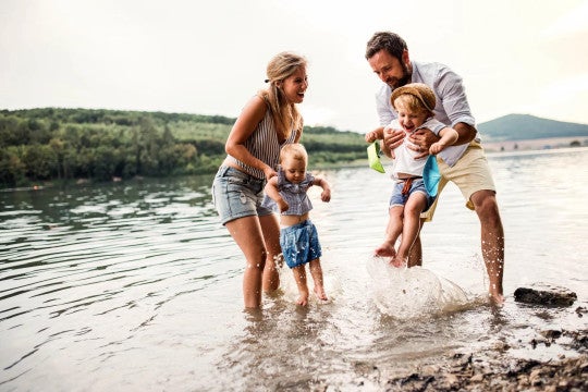 Two parents and two children playing in the water.