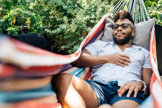 A man lounging in a hammock.