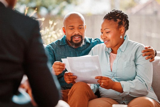 Man and woman reviewing mortgage information.