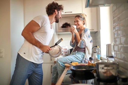 Young man and woman in kitchen.