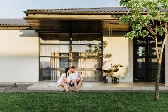 A man and woman sitting in a backyard setting.