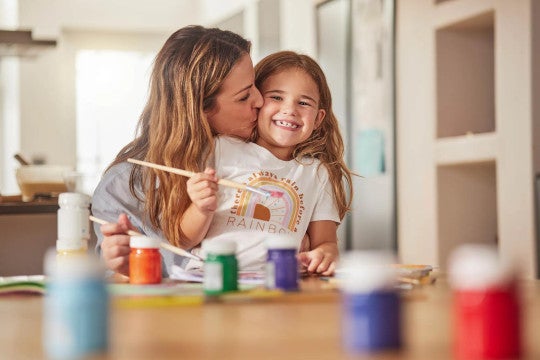 A woman and her daughter painting.