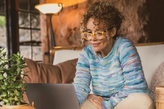 Middle-age woman looking at computer.
