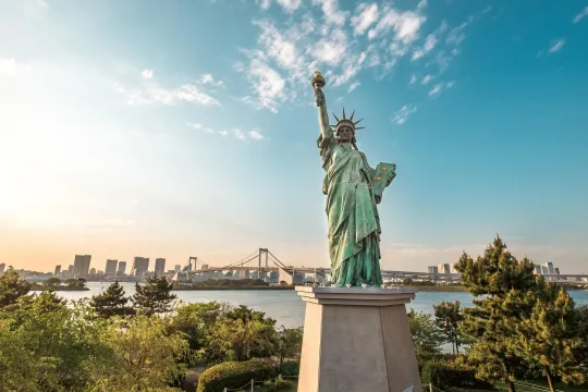 Statue of Liberty overlooking water and city skyline