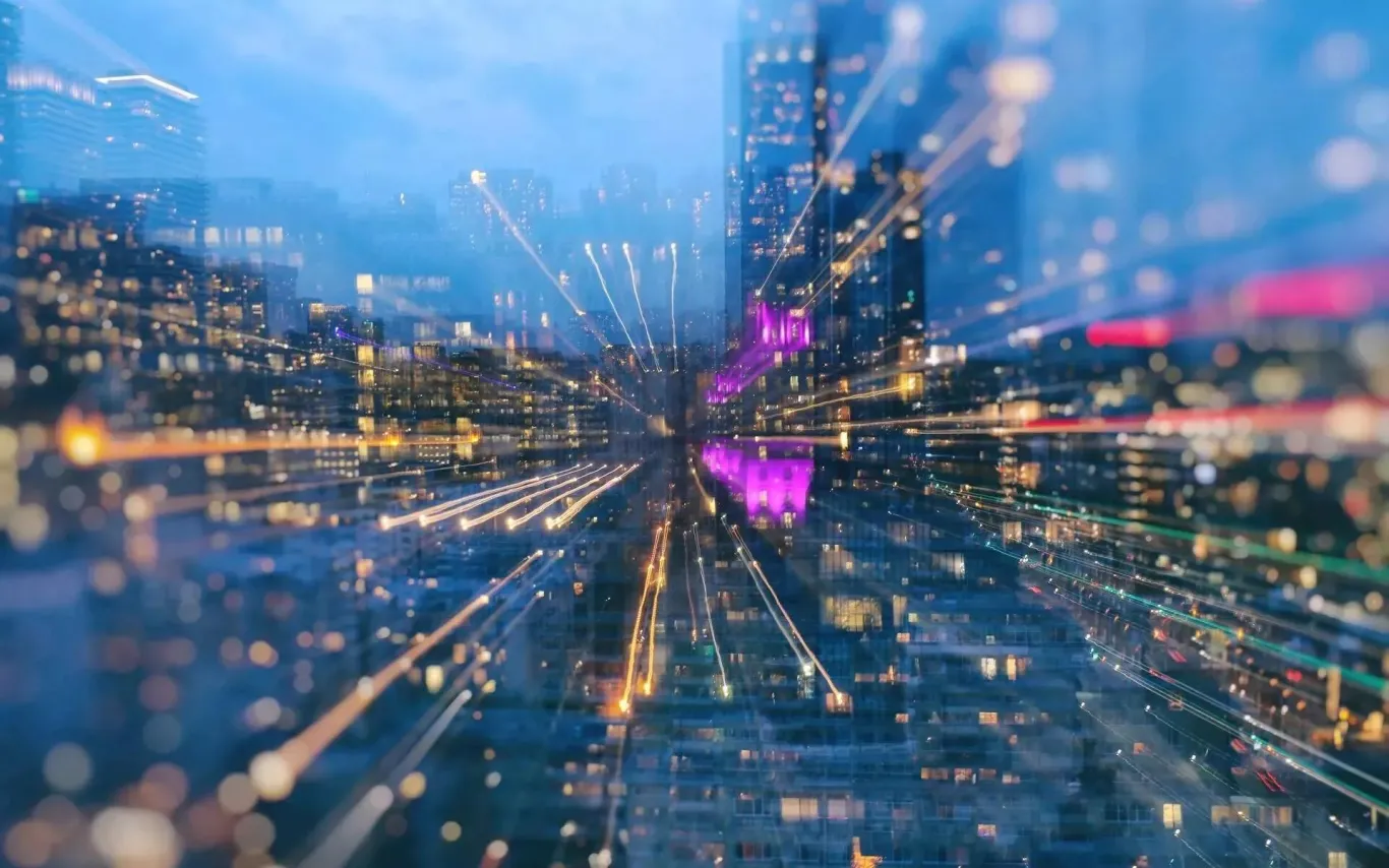 Graphic overlay of vibrant wires on top of a far-away view of skyscrapers.