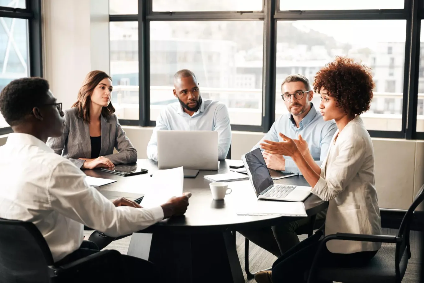 A group of business professionals meeting in an office setting.