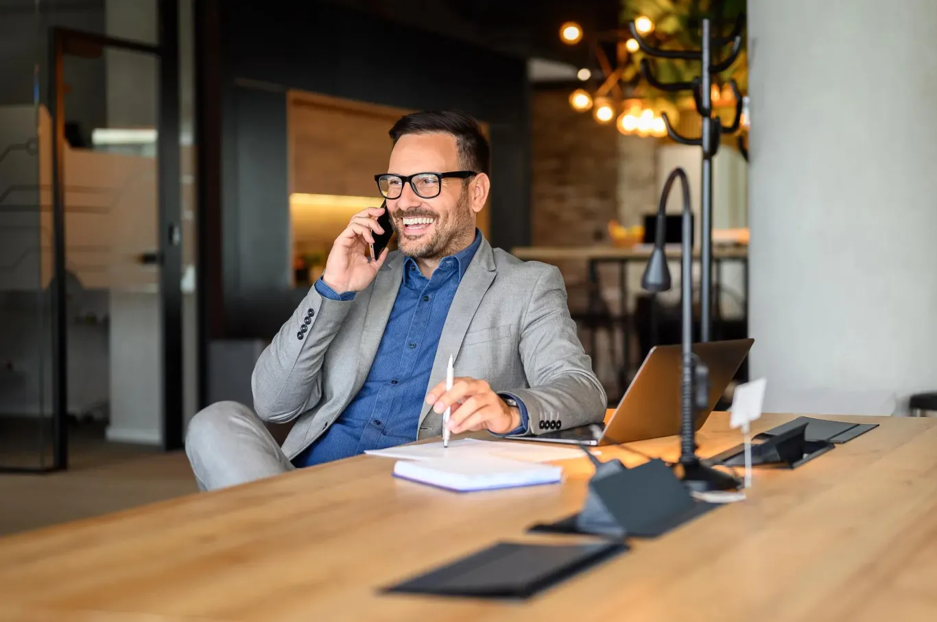 A small business owner talking on the telephone with his TPA