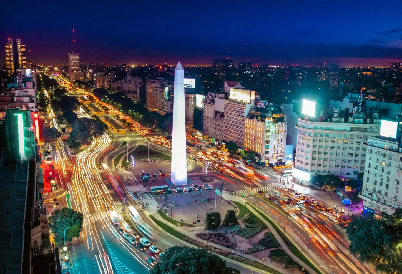 Colorful Aerial view of Buenos Aires and 9 de Julio Avenue at night.