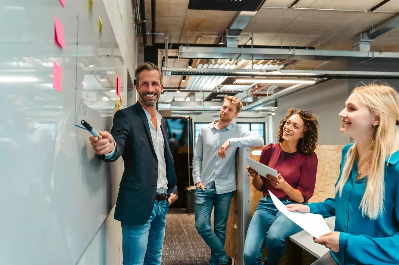 A manager explaining ESOP to a team on a whiteboard