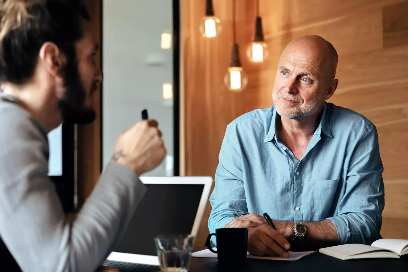 Two business partners sitting a desk discussing business strategy