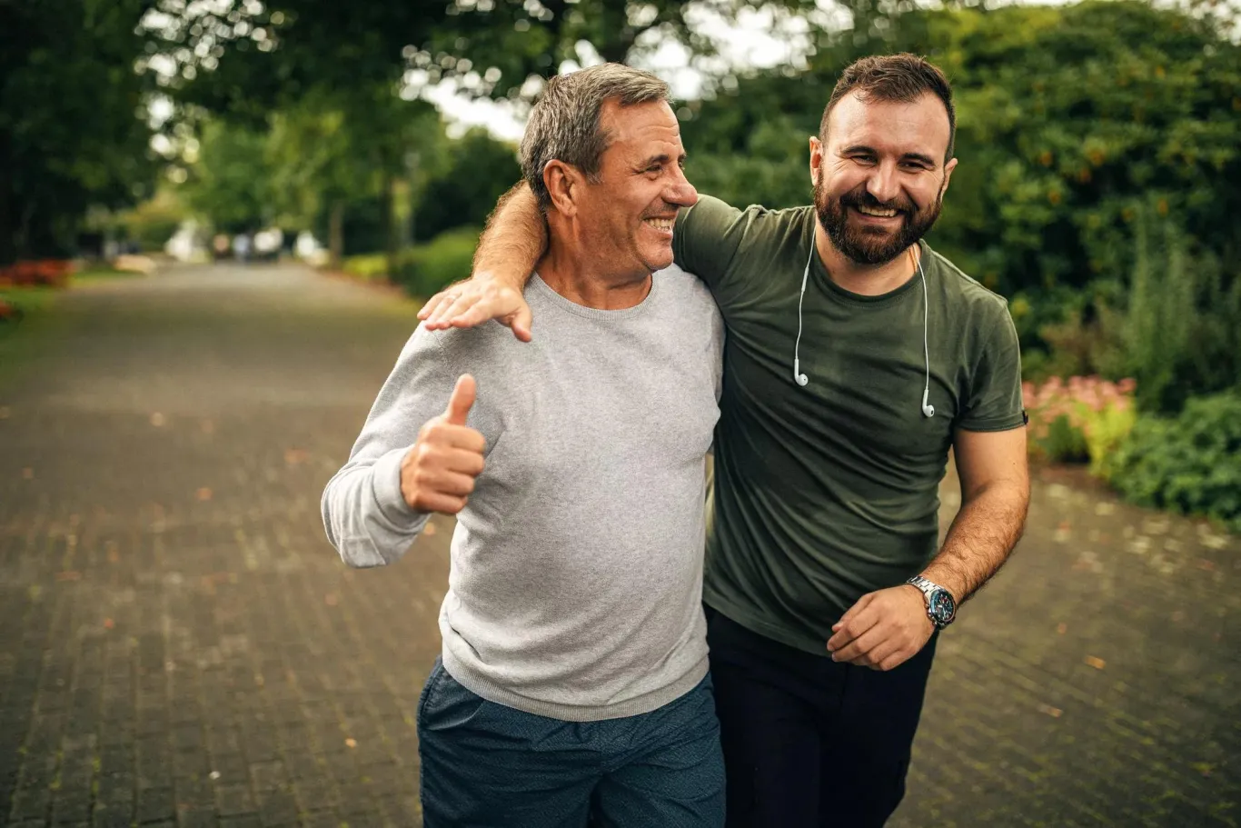 Two active men who have their arms wrapped around each other.