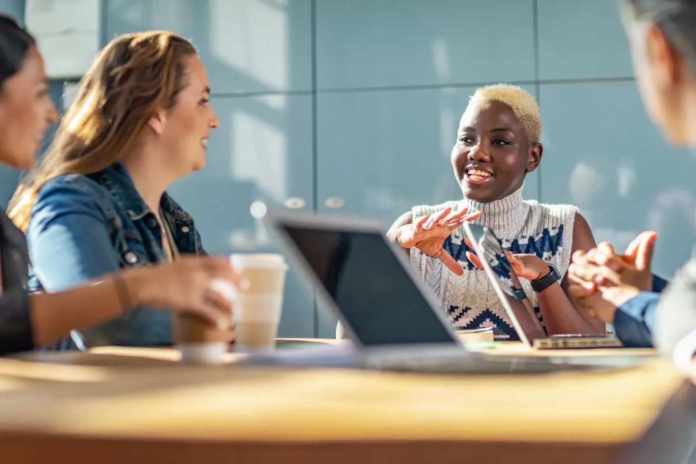 Employees sitting at a table discussing a plan for an upcoming business decision