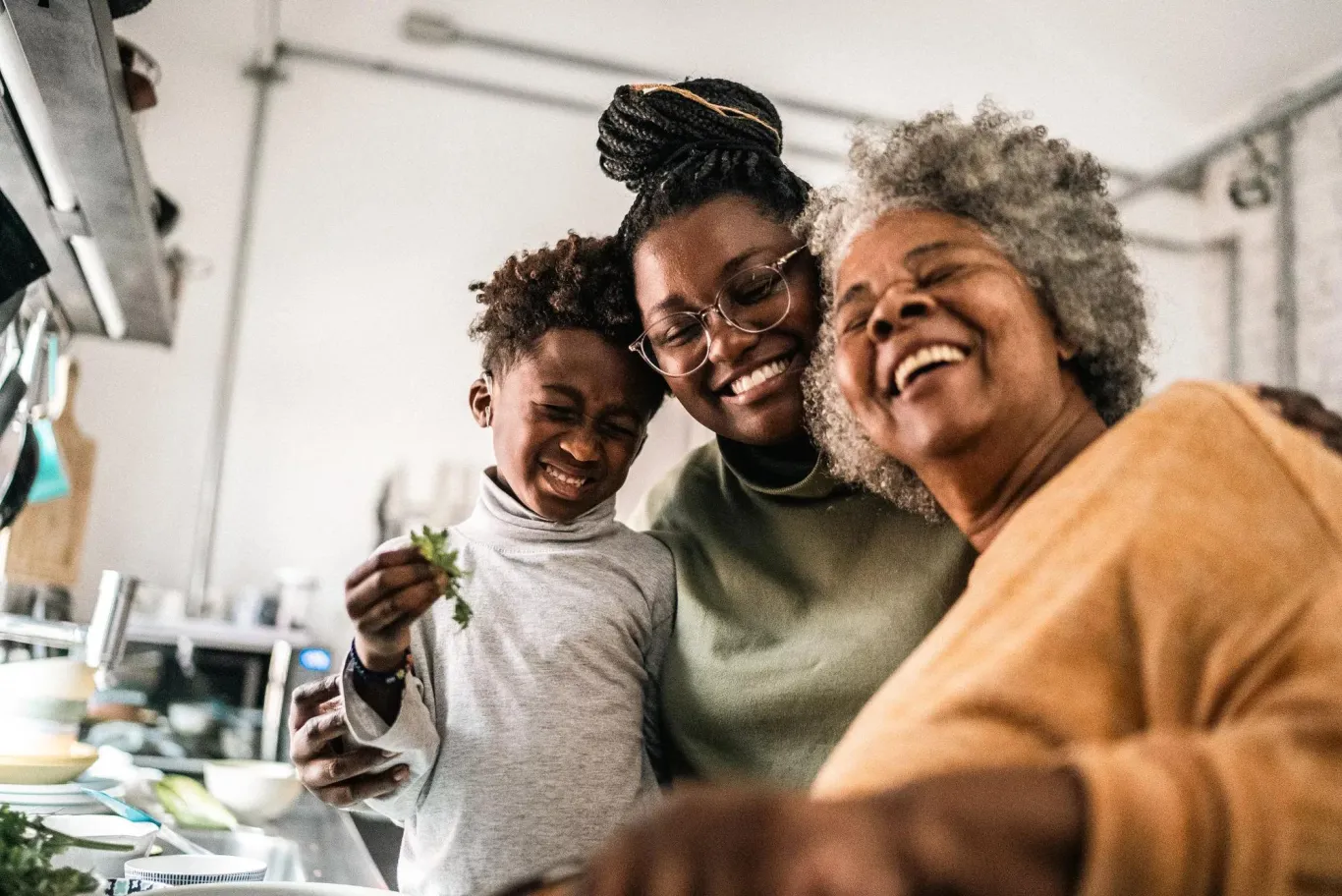 Three people smile warmly at the camera.