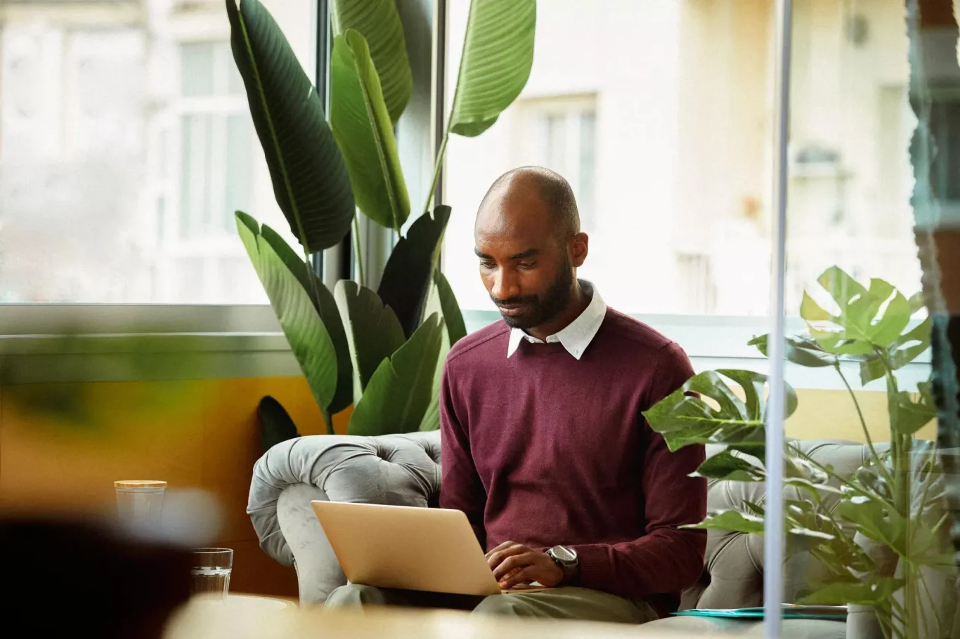 Man sitting and reading message on computer.
