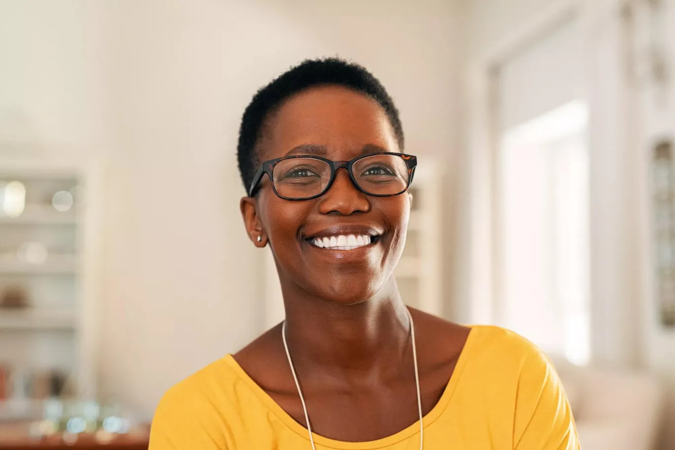 Smiling woman with glasses.