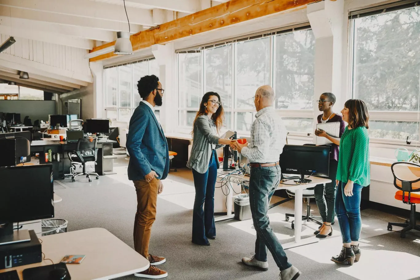 People shaking hands in an office. People shaking hands in an office.
