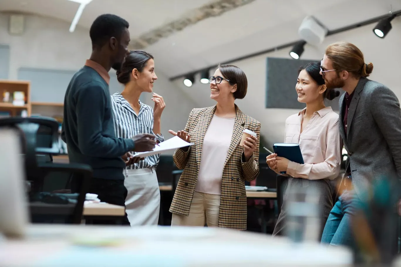 People conversing in an office. People conversing in an office.