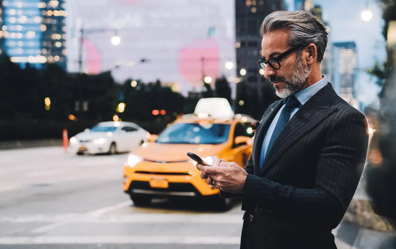 A man on his phone in the city.