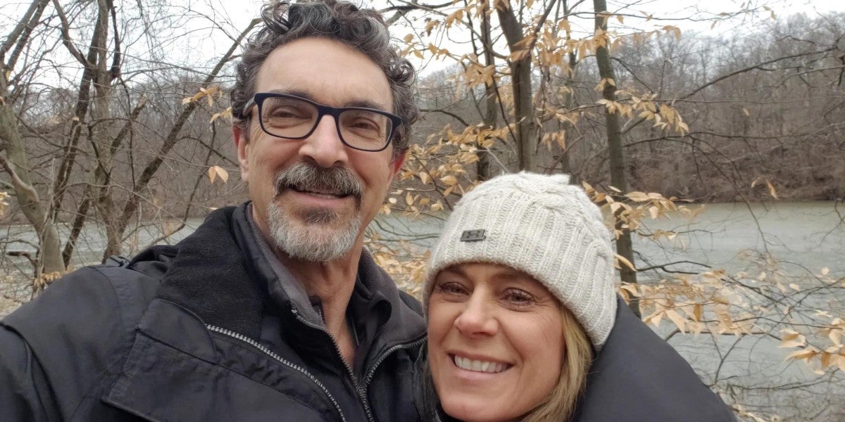 Man and woman smiling outside