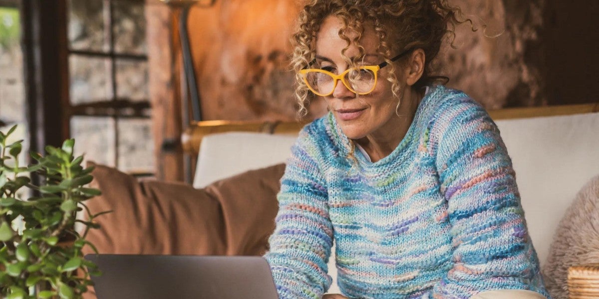 Middle-age woman looking at computer.