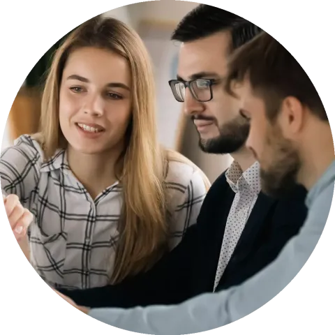 Colleagues discuss company financial paperwork together.