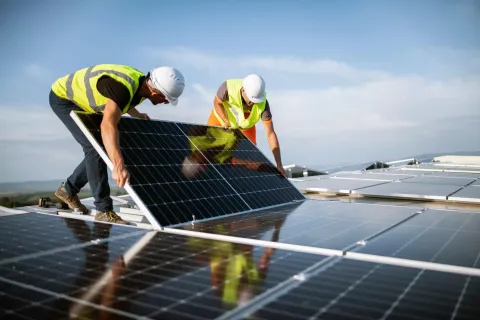 Workers with solar panels.