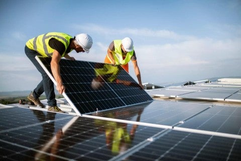Workers with solar panels.