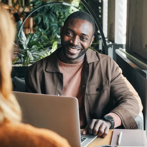 A business owner smiling in a meeting with their TPA