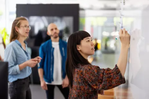 Woman using whiteboard.