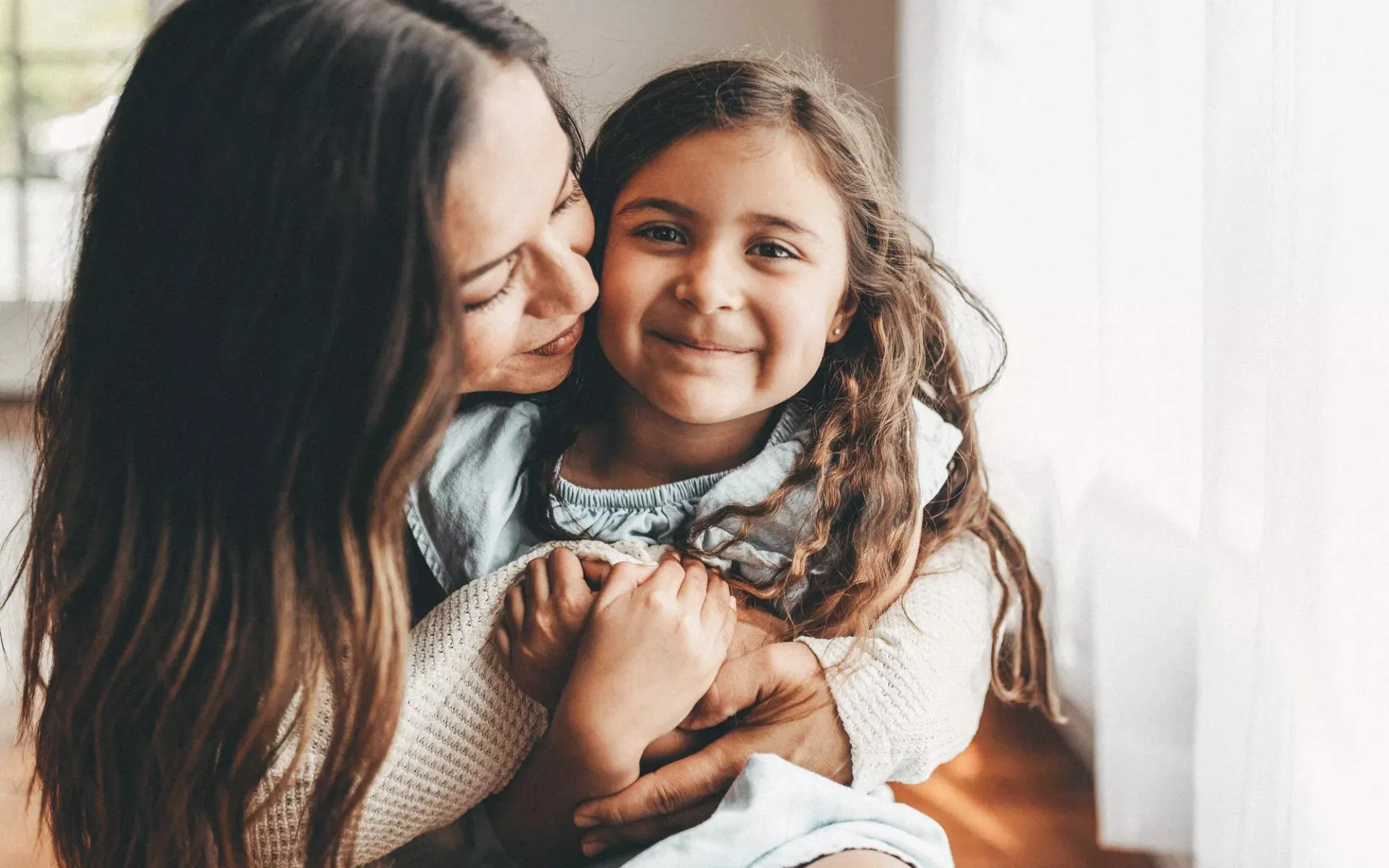 A mother hugging her child.